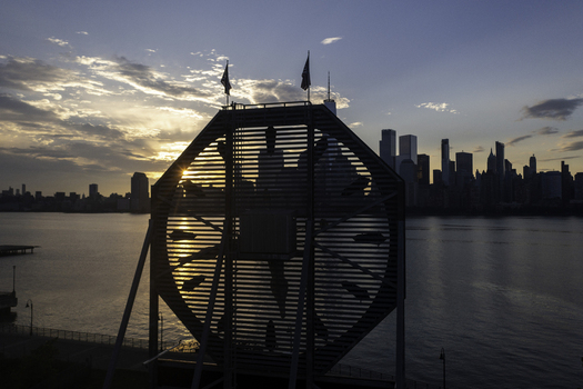 Aerial view of the Colgate Clock silhouette at sunset with the New York City skyline in the background featuring skyscrapers and the Hudson River in New York New York United States.