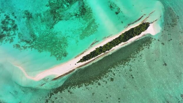 Aerial view of a tropical island with white sand in Maldives.