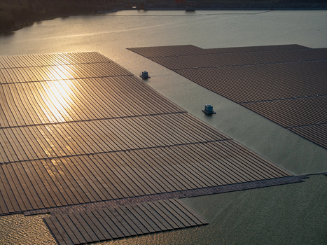 Aerial view of the floating solar power plant on the Sutami Dam reservoir at sunset in Kecamatan Sumberpucung Jawa Timur Indonesia. Aerial view of the floating solar power plant on the Sutami Dam reservoir at sunset in Kecamatan Sumberpucung Jawa Timur Indonesia.