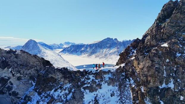 Aerial view of people on a snowy mountain ridge Greenland. Aerial view of people on a snowy mountain ridge Greenland.