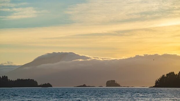View of misty mountains and islands over water United States.