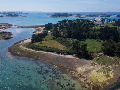 Aerial view of the rugged coastline and turquoise waters of Plage de Port Blanc with scattered islands and lush green vegetation in Penvenan Bretagne France. Aerial view of the rugged coastline and turquoise waters of Plage de Port Blanc with scattered islands and lush green vegetation in Penvenan Bretagne France.