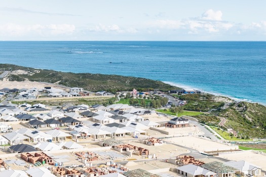 Aerial view of a modern residential development with new houses and construction sites situated along the coastline in Perth Western Australia Australia. Aerial view of a modern residential development with new houses and construction sites situated along the coastline in Perth Western Australia Australia.