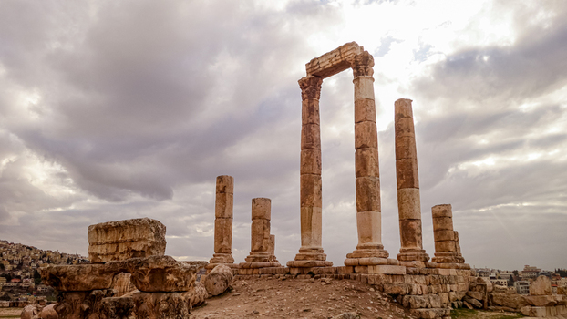 View of the ancient Roman columns of the Temple of Artemis standing against a cloudy sky in the archaeological site of Jerash Jerash Governorate Jordan. View of the ancient Roman columns of the Temple of Artemis standing against a cloudy sky in the archaeological site of Jerash Jerash Governorate Jordan.