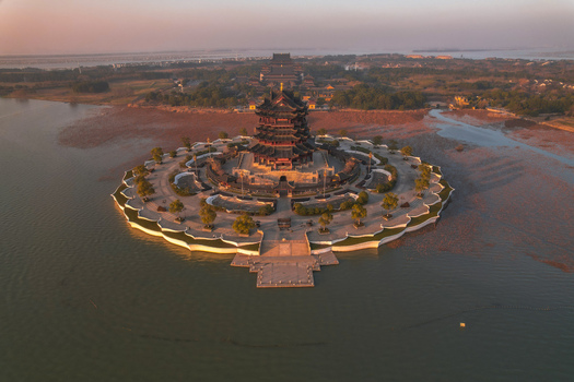 Aerial view of the multi tiered Chongyuan Temple pagoda on a circular island in Yangcheng Lake at sunset in Suzhou Jiang Su Sheng China.