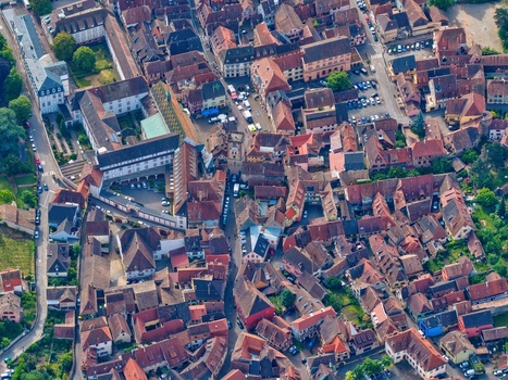 Aerial view of the historic old town center with traditional red tiled rooftops narrow streets and a central square with parked cars Ribeauville Grand Est France. Aerial view of the historic old town center with traditional red tiled rooftops narrow streets and a central square with parked cars Ribeauville Grand Est France.