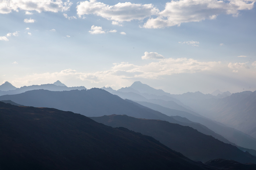 View of the majestic mountain ranges of Deosai National Park under a soft sky with layered peaks fading into the distance in Astore Gilgit Pakistan. View of the majestic mountain ranges of Deosai National Park under a soft sky with layered peaks fading into the distance in Astore Gilgit Pakistan.