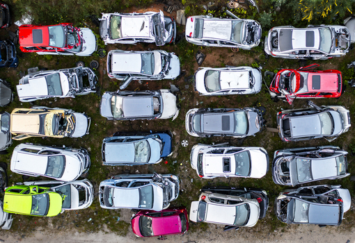Aerial view of a car junkyard filled with numerous wrecked and salvaged vehicles parked in rows on a dirt lot in Petah Tikva Center District Israel. Aerial view of a car junkyard filled with numerous wrecked and salvaged vehicles parked in rows on a dirt lot in Petah Tikva Center District Israel.