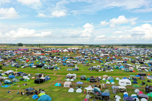 Herzogenaurach Germany 27 July 2025 Aerial view of Open Beatz Festival campsite with hundreds of colorful tents spread across green fields under a cloudy sky. Herzogenaurach Germany 27 July 2025 Aerial view of Open Beatz Festival campsite with hundreds of colorful tents spread across green fields under a cloudy sky.