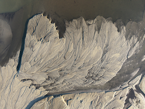 Aerial view of intricate sand textures and patterns formed by river water flowing through a delta in Poland. Aerial view of intricate sand textures and patterns formed by river water flowing through a delta in Poland.