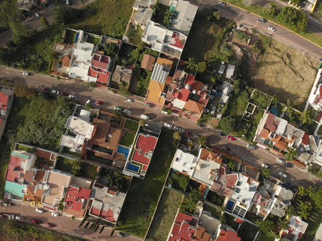 Aerial view of a residential neighborhood with red tiled rooftops swimming pools and streets in Tlaquepaque Jalisco Mexico. Aerial view of a residential neighborhood with red tiled rooftops swimming pools and streets in Tlaquepaque Jalisco Mexico.