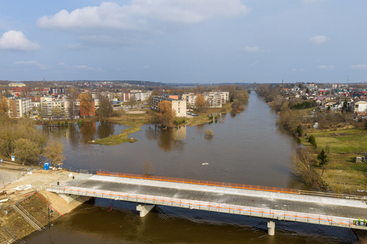 Kedainiai Lithuania 17 March 2026 Aerial view of the flooded Nevezis river overflowing its banks near residential buildings and a modern bridge under a blue sky. Kedainiai Lithuania 17 March 2026 Aerial view of the flooded Nevezis river overflowing its banks near residential buildings and a modern bridge under a blue sky.