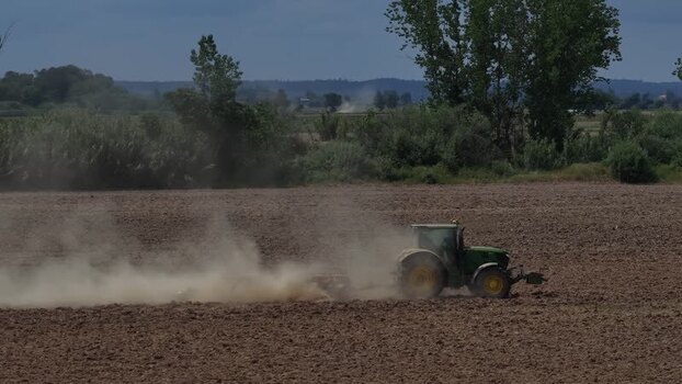 Aerial view of a green tractor plowing a field Portugal. Aerial view of a green tractor plowing a field Portugal.