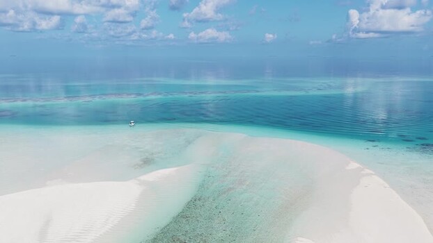 Aerial view of a white sandbar and turquoise lagoon Maldives.