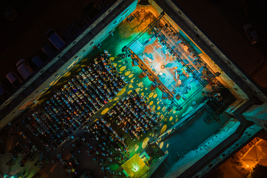 Svetvincenat Croatia 05 July 2026 Aerial view of an evening concert in the Morosini Grimani Castle courtyard featuring a stage with green lighting and rows of seated audience members. Svetvincenat Croatia 05 July 2026 Aerial view of an evening concert in the Morosini Grimani Castle courtyard featuring a stage with green lighting and rows of seated audience members.