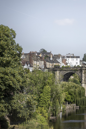 View of the historic Knaresborough Viaduct spanning the River Nidd with surrounding stone buildings and lush greenery in Knaresborough England United Kingdom.