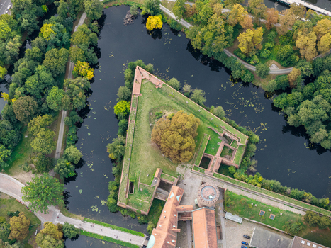 Aerial view of Spandau Citadel a historic fortress with triangular bastions surrounded by a moat and lush green parkland in Berlin Berlin Germany.