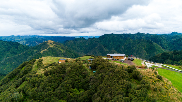 Aerial view of The Chef s Table at Blue Duck Station amidst rolling hills a vivid tapestry of green and brown under a dramatic sky Retaruke Manawatu Whanganui Region New Zealand. Aerial view of The Chef s Table at Blue Duck Station amidst rolling hills a vivid tapestry of green and brown under a dramatic sky Retaruke Manawatu Whanganui Region New Zealand.