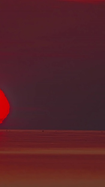 View of a vibrant red sunset over the sea in Latvia. View of a vibrant red sunset over the sea in Latvia.
