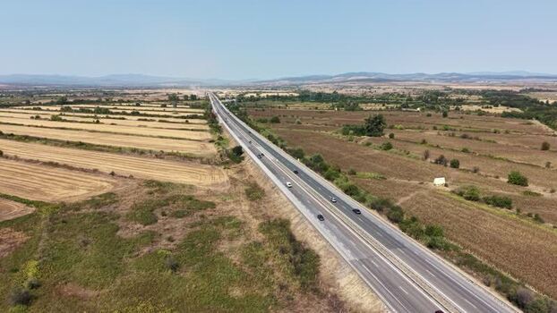 Aerial view of Trakiya Highway cutting through fields Bulgaria.