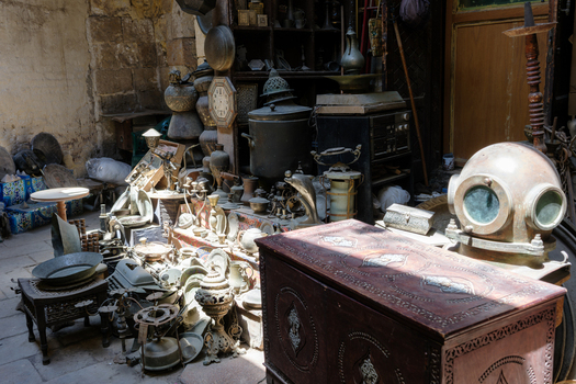 View of various antiques including a diving helmet and brass vessels at Khan el Khalili bazaar in El Gamaleya Cairo Governorate Egypt. View of various antiques including a diving helmet and brass vessels at Khan el Khalili bazaar in El Gamaleya Cairo Governorate Egypt.