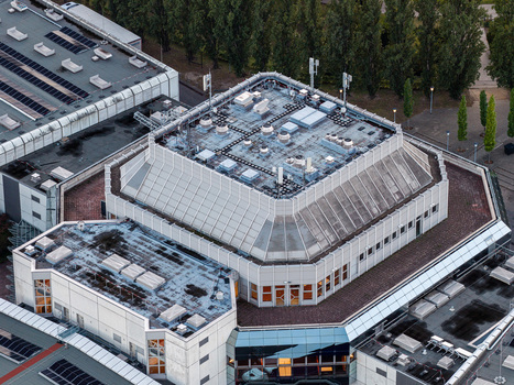 Aerial view of Messe Berlin exhibition center with its distinctive tiered roof structure and technical installations in Berlin Berlin Germany. Aerial view of Messe Berlin exhibition center with its distinctive tiered roof structure and technical installations in Berlin Berlin Germany.