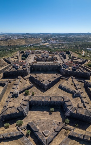 Elvas Portugal 10 September 2026 Aerial view of the star shaped Forte de Nossa Senhora da Graca with its historic stone fortifications bastions and surrounding landscape under a clear blue sky. Elvas Portugal 10 September 2026 Aerial view of the star shaped Forte de Nossa Senhora da Graca with its historic stone fortifications bastions and surrounding landscape under a clear blue sky.