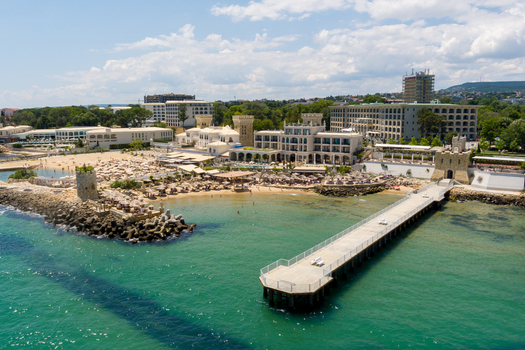 Aerial view of the Saints Constantine and Helena resort featuring a long pier sandy beach and historic architecture in Saints Constantine and Helena Varna Bulgaria.