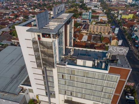 Aerial view of the Aston Hotel featuring modern architecture and rooftop signage amidst the dense urban landscape of Purwokerto Central Java Indonesia. Aerial view of the Aston Hotel featuring modern architecture and rooftop signage amidst the dense urban landscape of Purwokerto Central Java Indonesia.