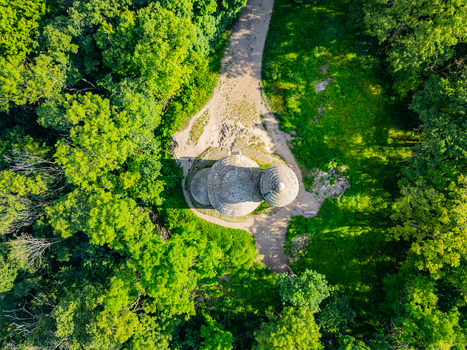 Aerial view of the historic Rotunda of Saint George atop Rip Mountain surrounded by lush green forest in Mnetes Usti nad Labem Region Czechia. Aerial view of the historic Rotunda of Saint George atop Rip Mountain surrounded by lush green forest in Mnetes Usti nad Labem Region Czechia.