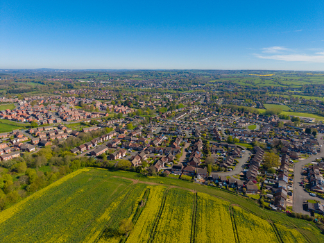 Aerial view of the town of Stone surrounded by lush green fields and residential neighborhoods in Stone England United Kingdom. Aerial view of the town of Stone surrounded by lush green fields and residential neighborhoods in Stone England United Kingdom.