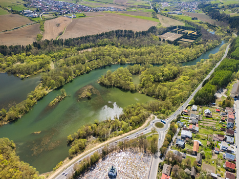 Aerial view of Oravska priehrada reservoir with lush green forests a cemetery and a road roundabout Namestovo Zilinsky kraj Slovakia. Aerial view of Oravska priehrada reservoir with lush green forests a cemetery and a road roundabout Namestovo Zilinsky kraj Slovakia.