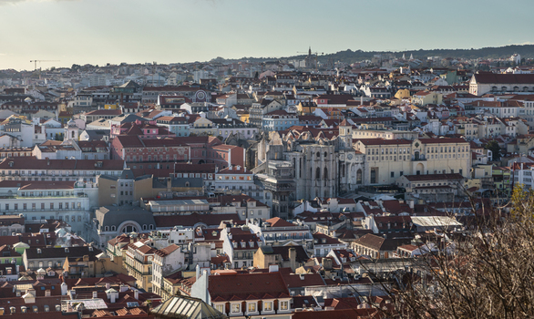 Aerial view of the historic city of Lisbon featuring the ruins of the Carmo Convent dense urban rooftops and traditional architecture in Lisbon Lisbon Portugal.