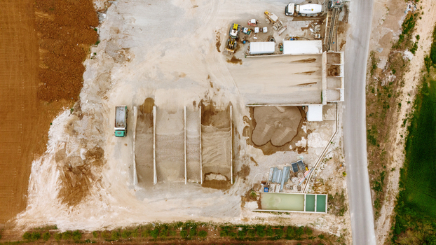 Aerial view of a concrete batching plant with aggregate storage bays conveyor belts and heavy machinery on an industrial site Sabac Serbia.