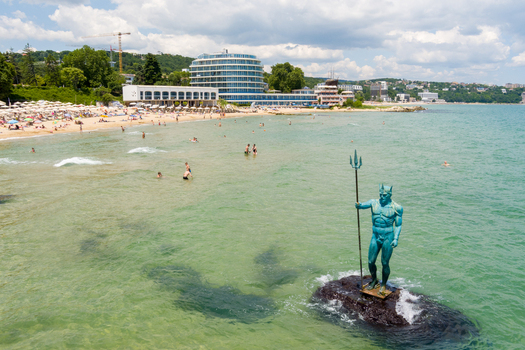 Aerial view of the Neptune statue standing in the turquoise waters of the Black Sea at the beach in Saints Constantine and Helena Varna Bulgaria.