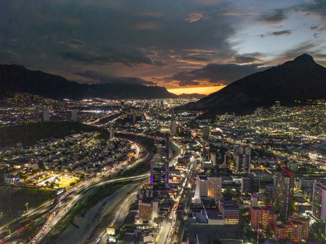 Aerial view of the illuminated cityscape of Monterrey at night featuring glowing urban lights modern skyscrapers and surrounding mountains in Monterrey Nuevo Leon Mexico. Aerial view of the illuminated cityscape of Monterrey at night featuring glowing urban lights modern skyscrapers and surrounding mountains in Monterrey Nuevo Leon Mexico.