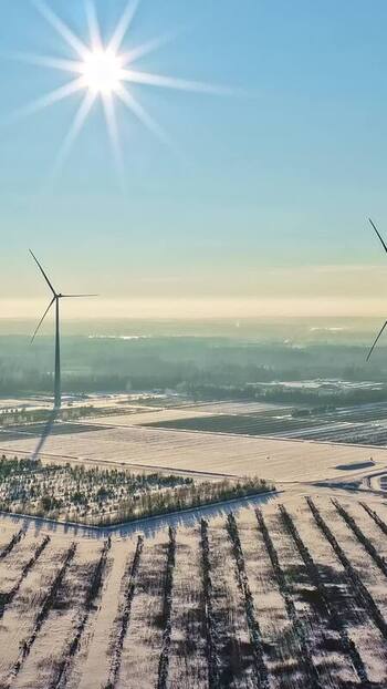 Aerial view of wind turbines in a snowy landscape Latvia.