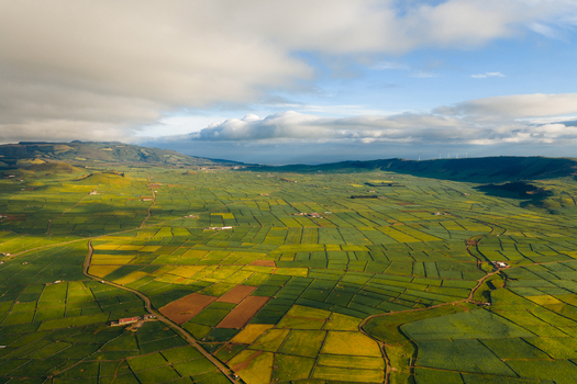 Aerial view of Pico Dona Joana and the patchwork of agricultural fields under a cloudy sky in Feteira Acores Portugal. Aerial view of Pico Dona Joana and the patchwork of agricultural fields under a cloudy sky in Feteira Acores Portugal.