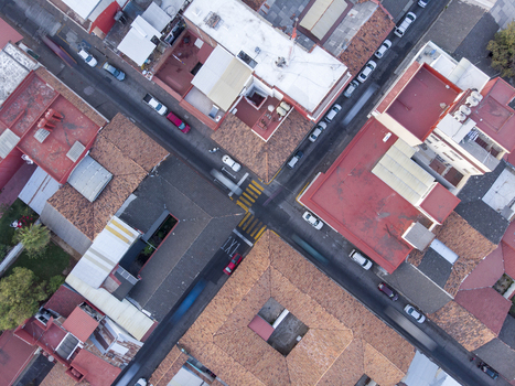 Aerial view of the historic Centro district in Uruapan featuring terracotta rooftops narrow streets with parked cars and urban architecture in Uruapan Michoacan Mexico.