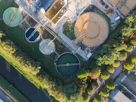 Aerial view of a wastewater treatment plant with circular sedimentation tanks industrial infrastructure and surrounding greenery in Vilvoorde Flanders Belgium. Aerial view of a wastewater treatment plant with circular sedimentation tanks industrial infrastructure and surrounding greenery in Vilvoorde Flanders Belgium.