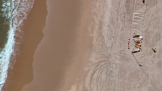Aerial view of Tamariz Beach with people on the sand Portugal.