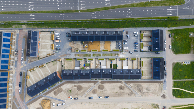 Aerial view of modern residential houses with solar panels on rooftops and parked cars in a new housing development Utrecht Utrecht Netherlands. Aerial view of modern residential houses with solar panels on rooftops and parked cars in a new housing development Utrecht Utrecht Netherlands.