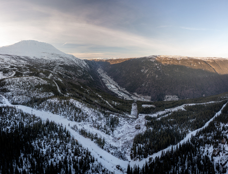 Aerial view of Gaustablikk Fjellresort nestled in the snow covered mountains with ski slopes and pine forests in Rjukan Telemark Norway. Aerial view of Gaustablikk Fjellresort nestled in the snow covered mountains with ski slopes and pine forests in Rjukan Telemark Norway.