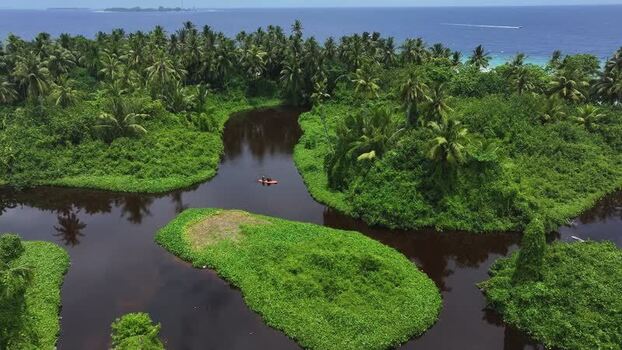 Aerial view of a kayak on a tropical lake in Kamadhoo Maldives. Aerial view of a kayak on a tropical lake in Kamadhoo Maldives.