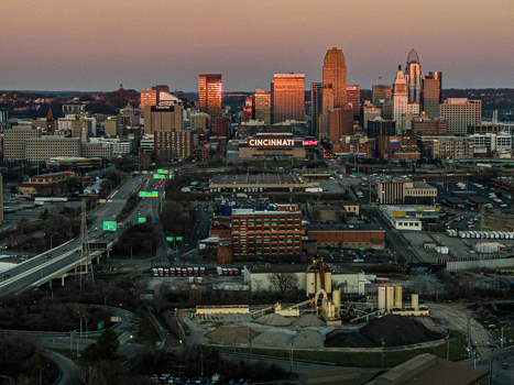Aerial view of Cincinnati s skyline ablaze with the warm hues of sunset casting long shadows over the cityscape and the Ohio River Cincinnati Ohio United States. Aerial view of Cincinnati s skyline ablaze with the warm hues of sunset casting long shadows over the cityscape and the Ohio River Cincinnati Ohio United States.