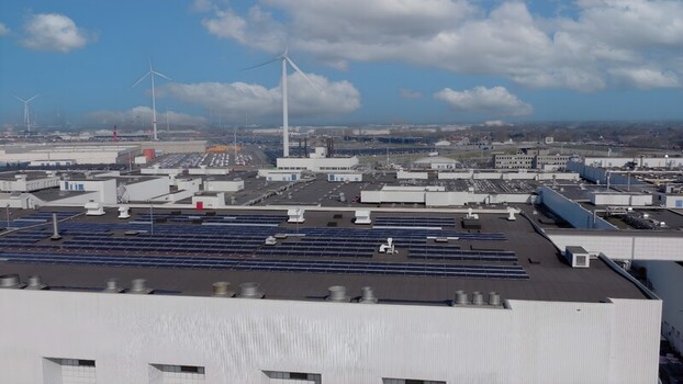 Aerial view of the Auto Industriale Bergamasca S.p.A. facility with rooftop solar panels industrial infrastructure and wind turbines in Dalmine Lombardia Italy. Aerial view of the Auto Industriale Bergamasca S.p.A. facility with rooftop solar panels industrial infrastructure and wind turbines in Dalmine Lombardia Italy.