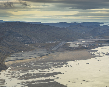 Aerial view of an airport runway cutting through the stark rocky landscape where earth meets sea a dance of light and shadow Narsarsuaq Greenland. Aerial view of an airport runway cutting through the stark rocky landscape where earth meets sea a dance of light and shadow Narsarsuaq Greenland.
