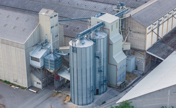 Aerial view of grain silos connected by conveyor systems at an agricultural storage and processing facility in Le Pouzin Auvergne Rhone Alpes France.
