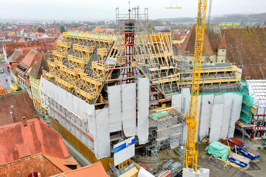 Aerial view of Rathaus Forchheim under renovation with scaffolding and a construction crane among historic rooftops in Forchheim Bayern Germany. Aerial view of Rathaus Forchheim under renovation with scaffolding and a construction crane among historic rooftops in Forchheim Bayern Germany.