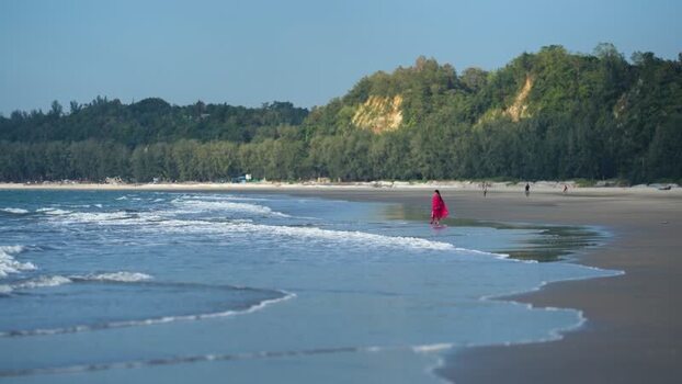 View of a woman walking on the beach in Cox s Bazar Bangladesh. View of a woman walking on the beach in Cox s Bazar Bangladesh.
